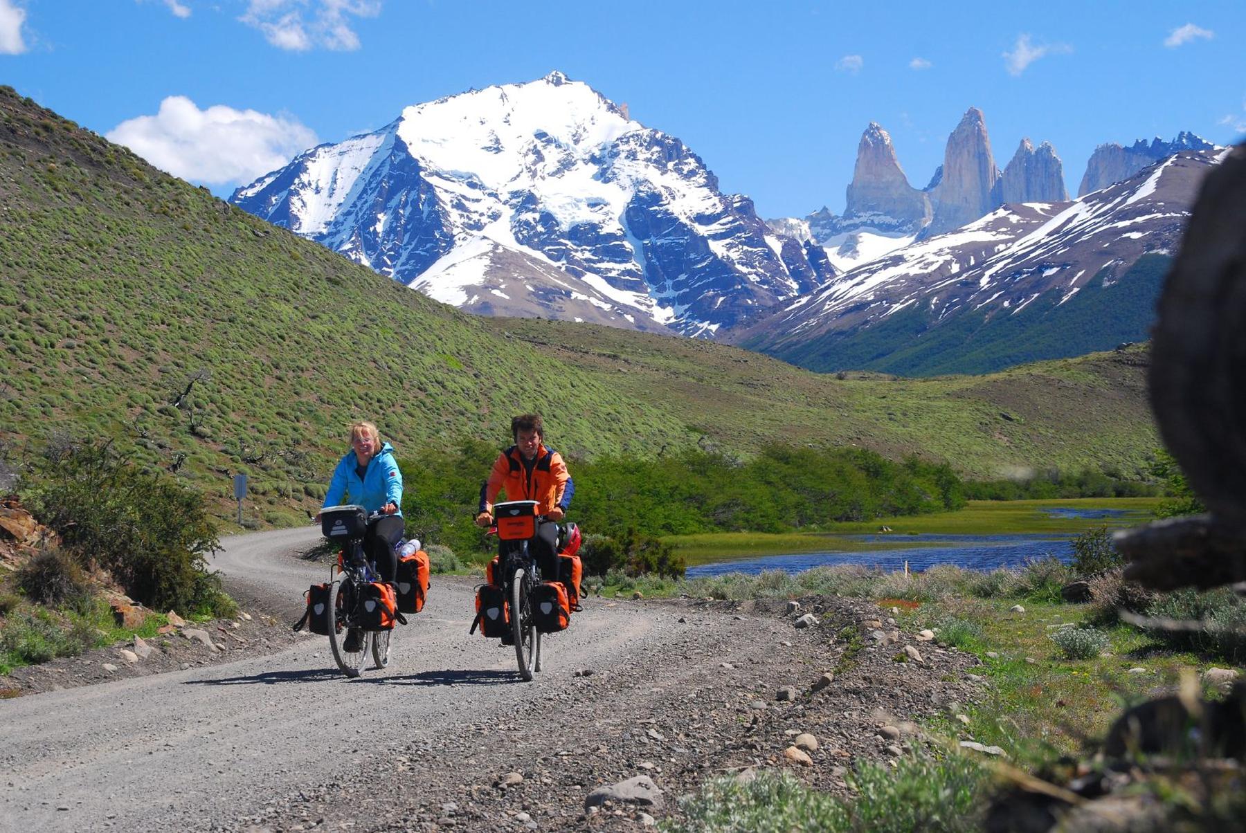 two people riding bikes on a trail through the mountains - File:027 Cycling Torres del Paine.jpg