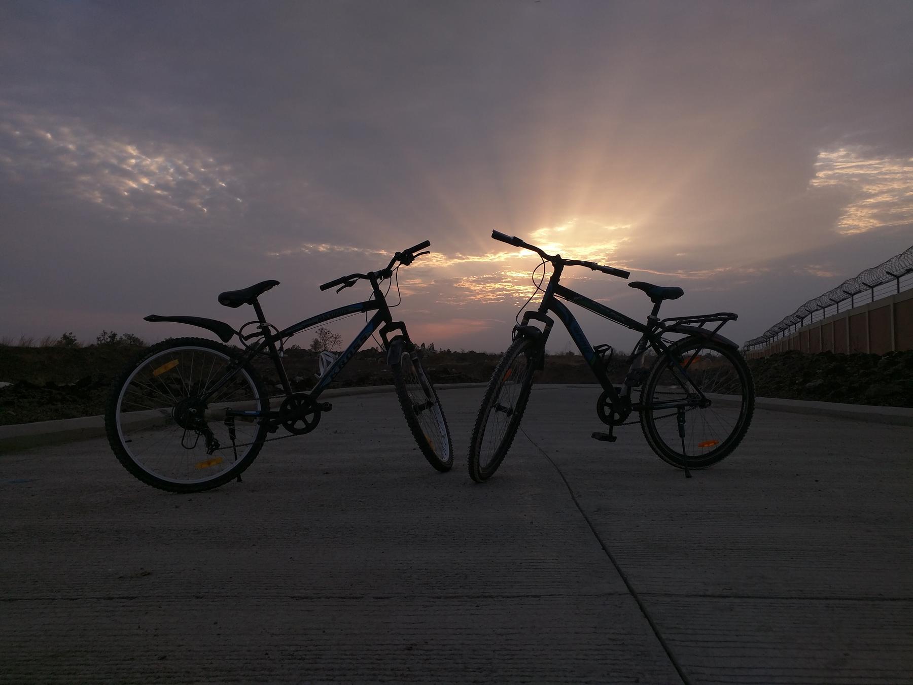 File:Sunrise 07.jpg - two bikes parked in front of a sunset