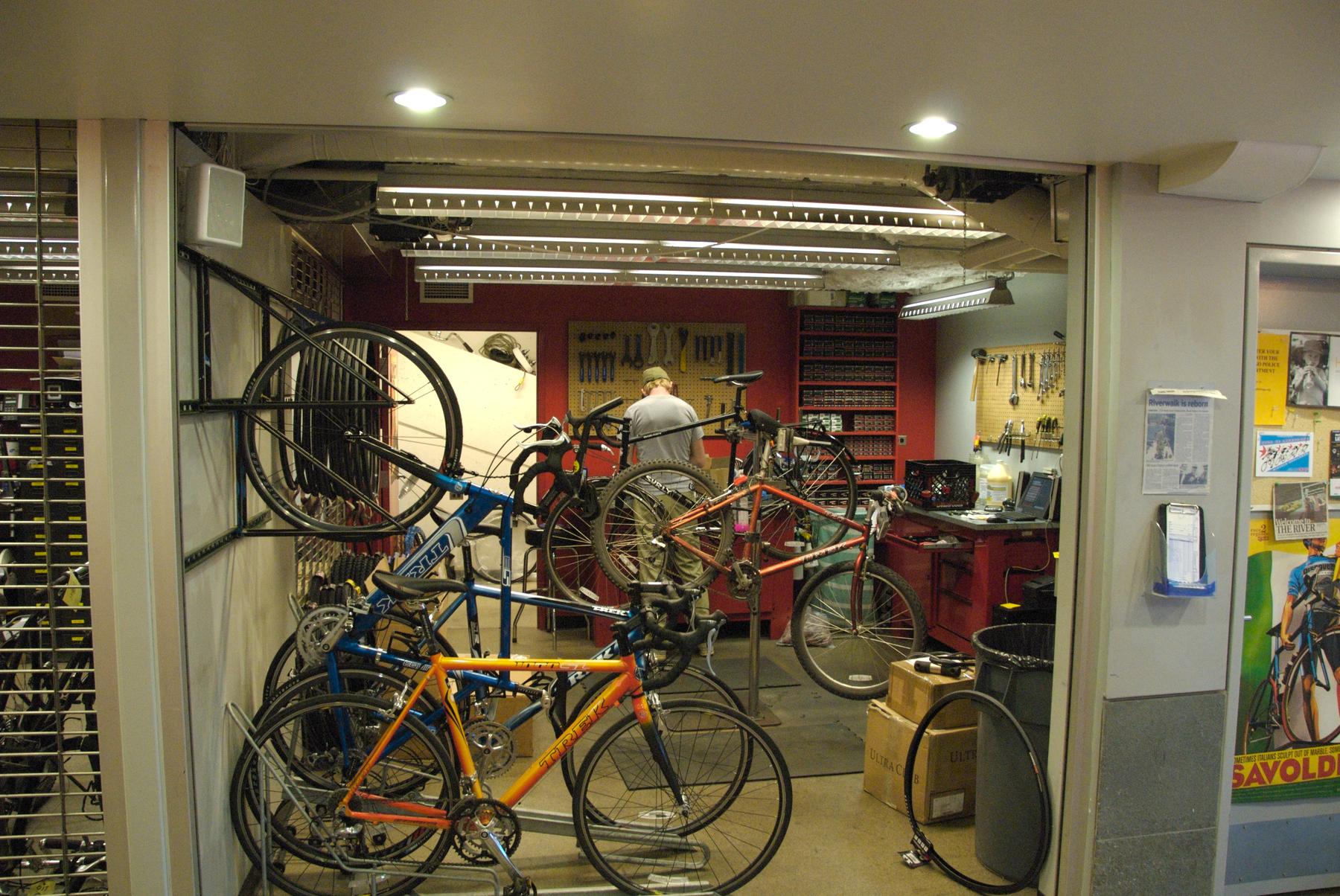 File:McDonald's Cycle Center Repair Shop.jpg - a room with a bunch of bikes in it
